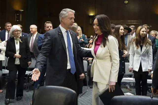 Sen. Roger Marshall shows a pin to Brooke Rollins before a Senate Agriculture Committee hearing